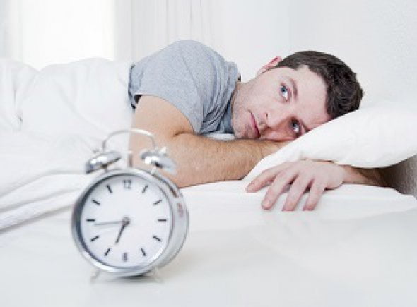 You Can'T Catch Up On Lost Sleep, New Study Says 1 A Man Trying To Sleep In Front Of An Alarm Clock