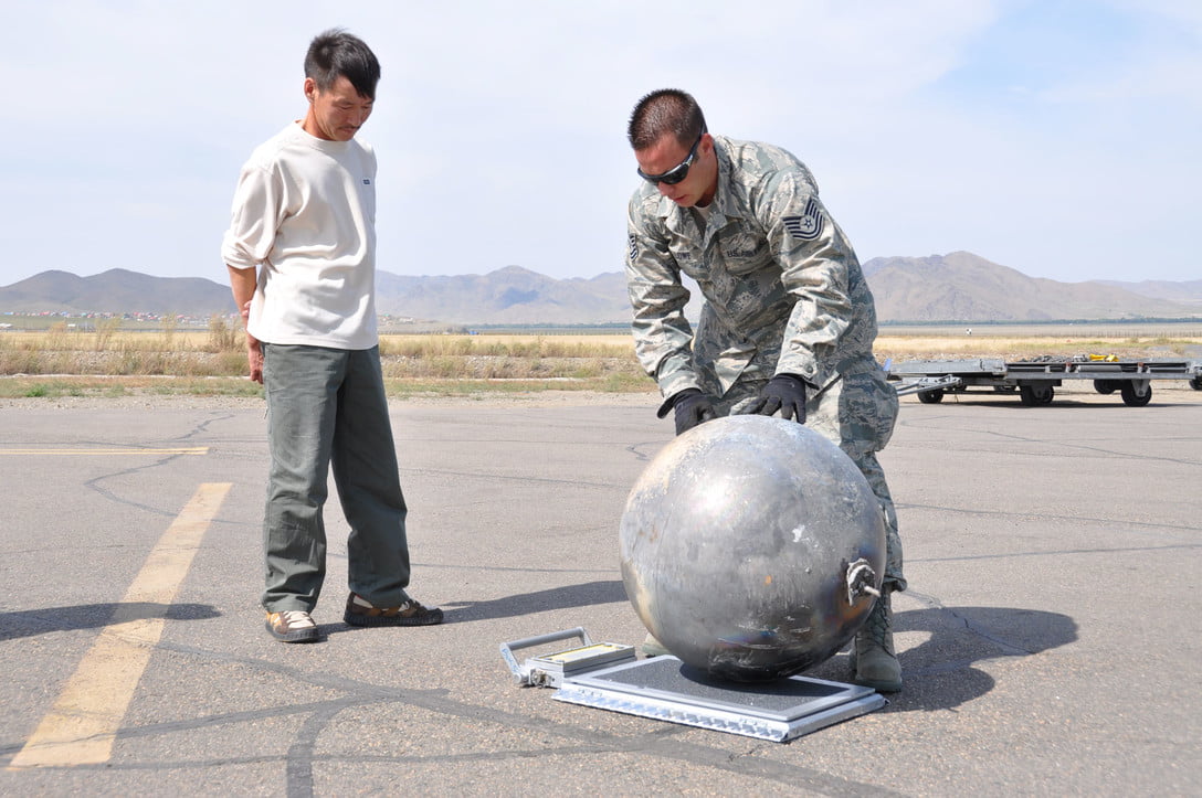 Creating A Global Plan To Manage Space Traffic 2 A Local Person Observes An Army Personal Standing At The Chinggis Khaan International Airport, Mongolia Weighing A Hydrogen Fuel Tank