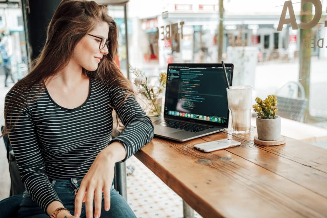 4 Trends In Full-Stack Development That You Should Follow In 2021 3 A Girl Who Codes Sitting On A Table With Her Table