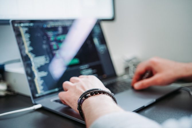 4 Trends In Full-Stack Development That You Should Follow In 2021 1 A Person Coding On A Laptop