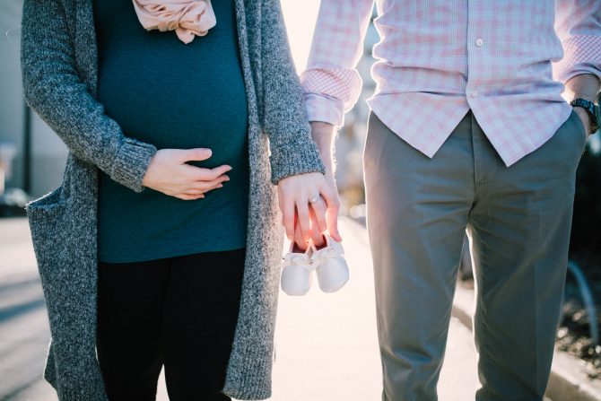 3 Signs Your Portable Ultrasound May Need Repairs 2 A Photo Of Husband And A Pregnant Wife Holding Hands And Pair Of Shoes For A Child