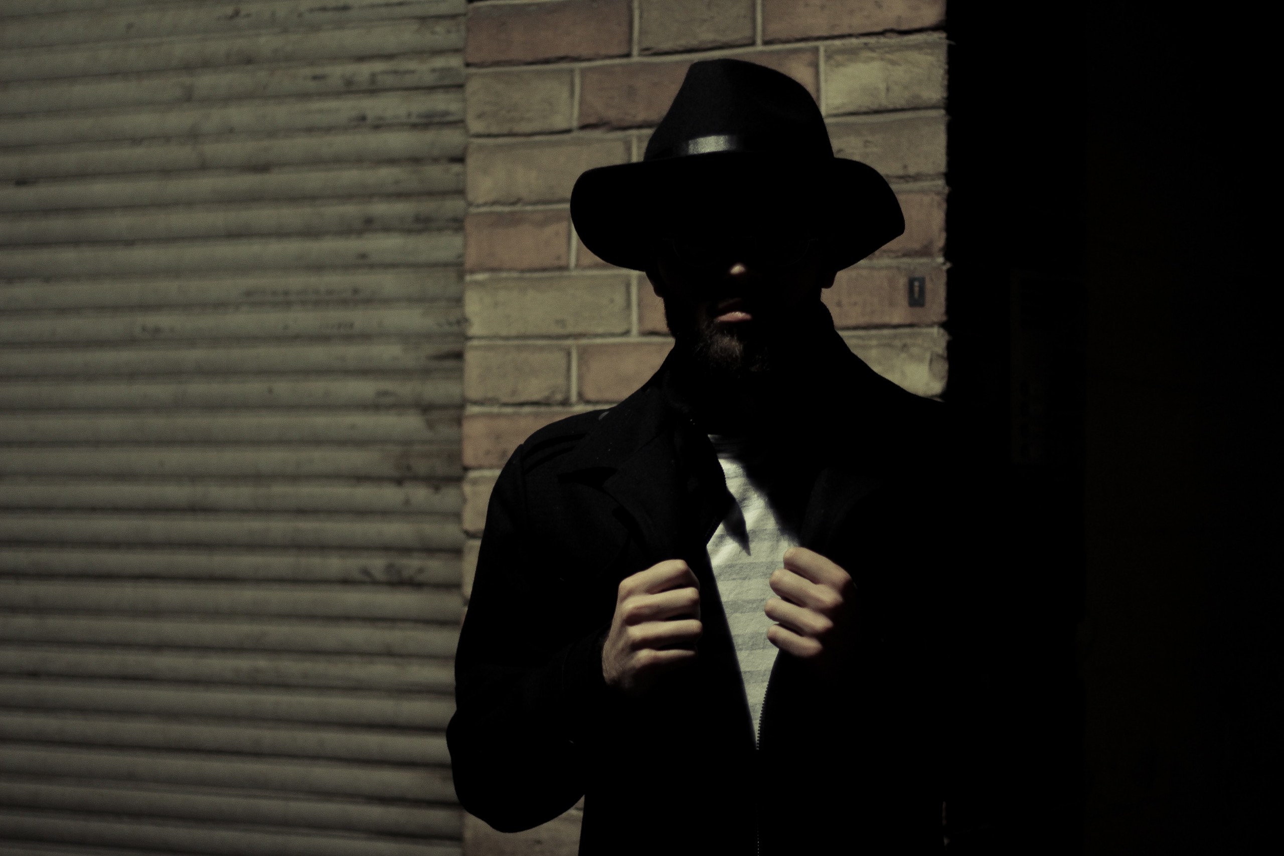 Photo of a man wearing black fedora hat
