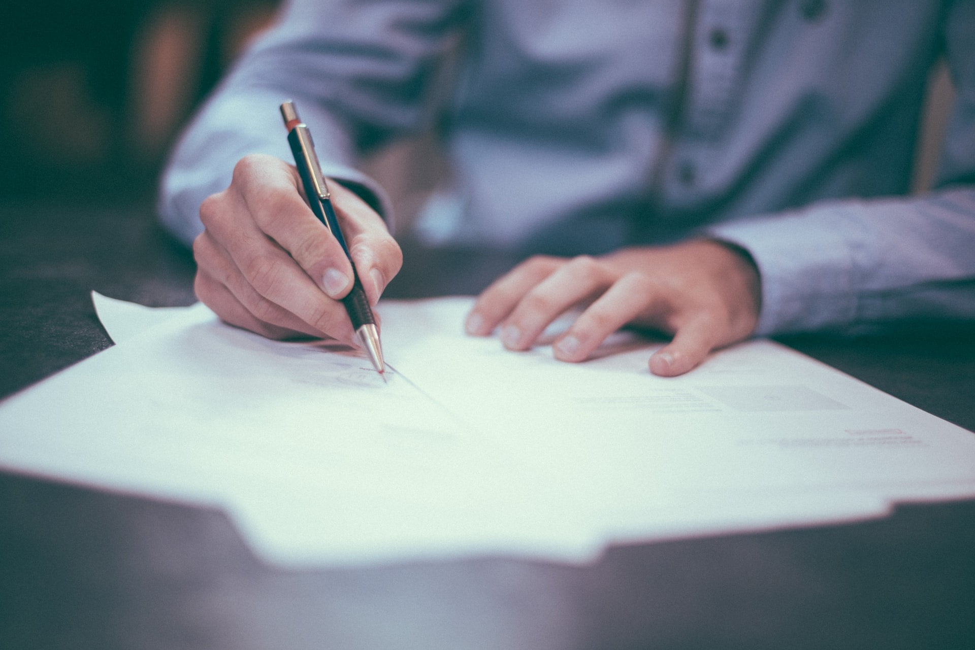 A person signing on a document