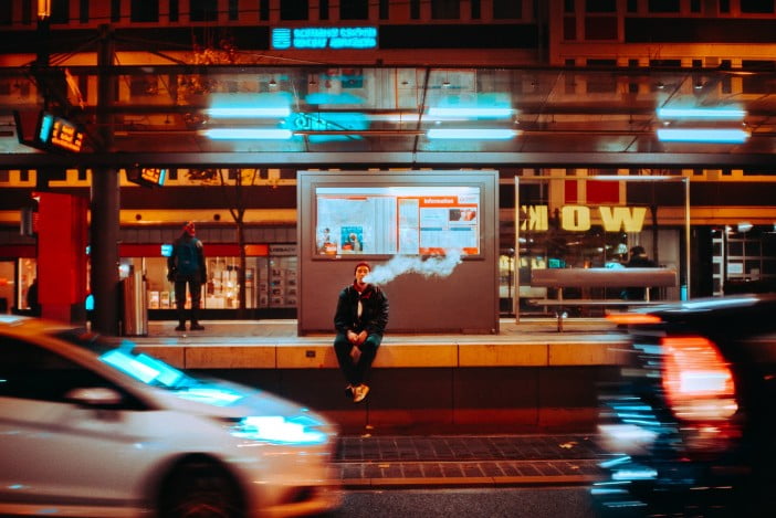 How Safe Is Vaping: Main Health Threats 4 A Person Vaping On A Sidewalk In The City