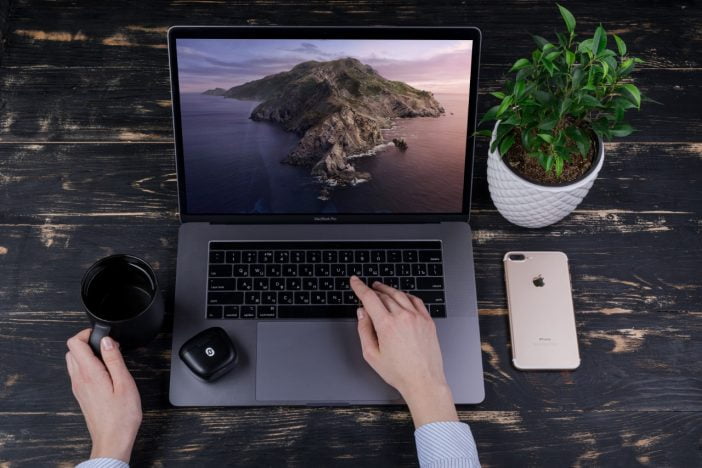 Why Artificial Intelligence Is The Future Of Headphones 3 A Person Using Laptop Along With Redux Headphones