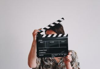 A woman holding movie roll