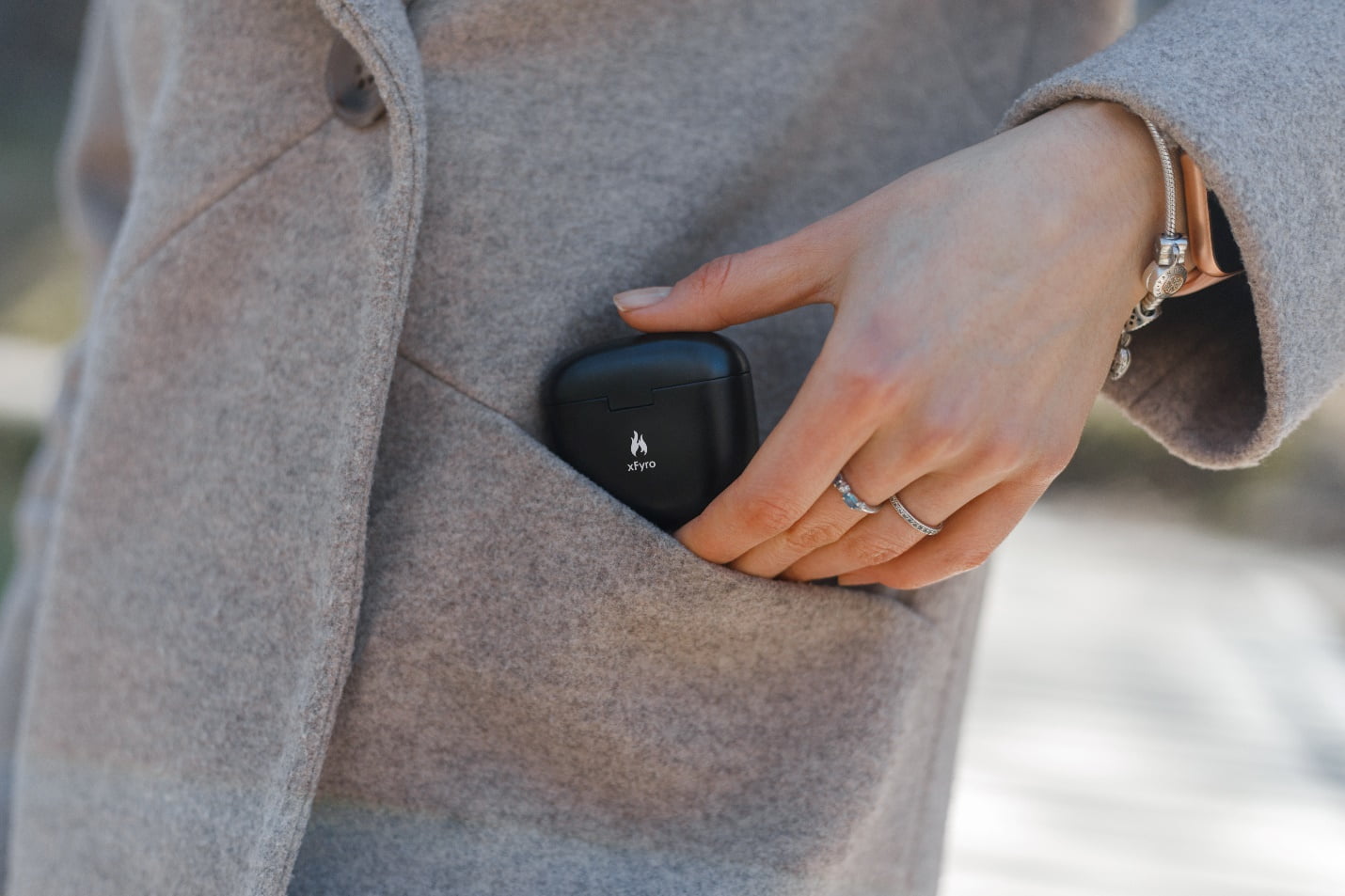 Will Xfyro’s New Ai-Powered Earbuds Make Airpods Pro Obsolete? 4 A Woman Putting Xfyro Earphones In Her Coat