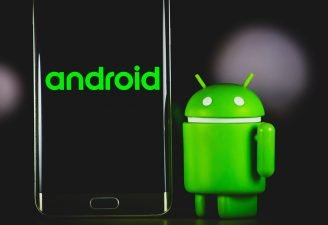 An Android dummy standing near an Android phone