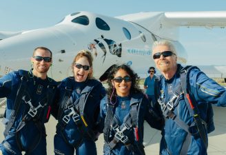 Richard branson cheering up with his crew in fron of Unity VSS rocket plane
